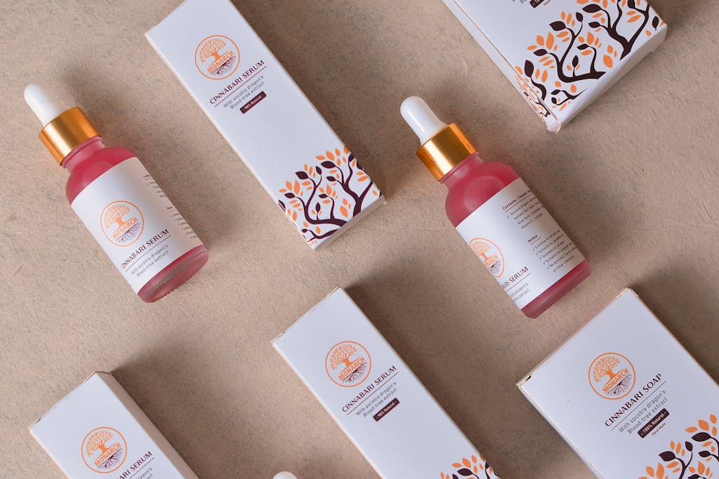 Flat lay of cosmetic serum bottles and boxes for beauty and skincare.