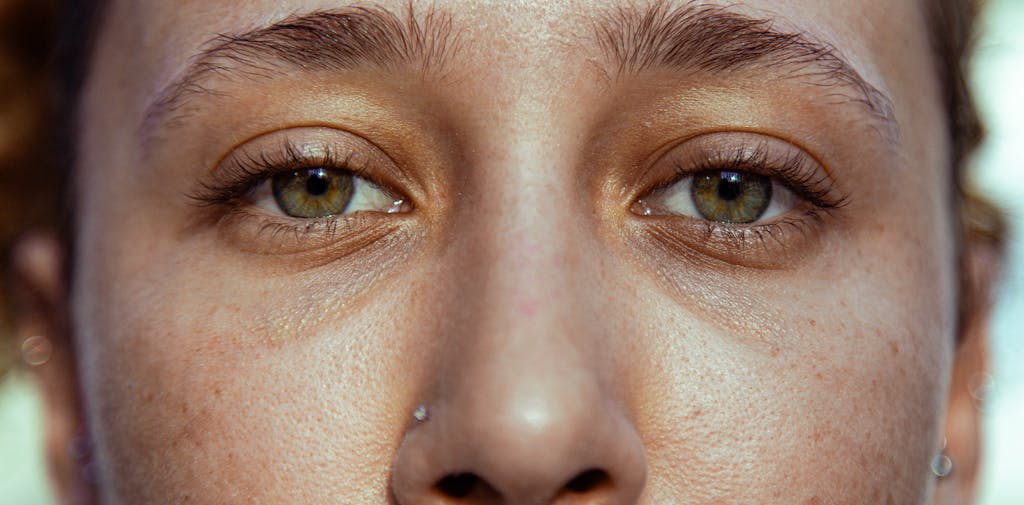 Intimate close-up of a woman's eyes and brow, expressing emotion and depth.