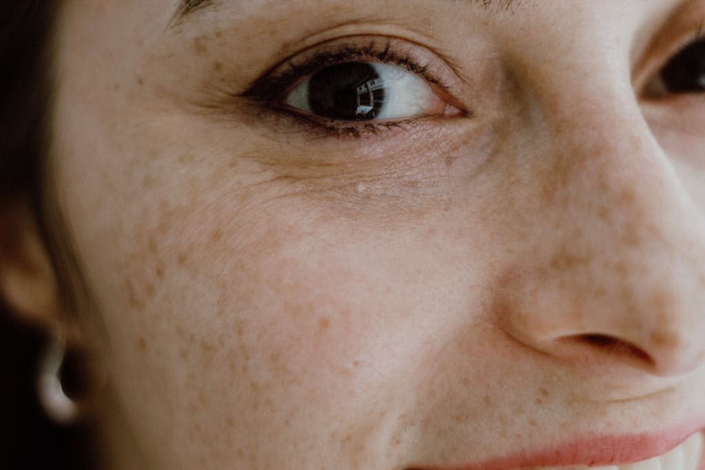 Intimate close-up portrait capturing the detailed freckles and vibrant eye of a woman in İstanbul.