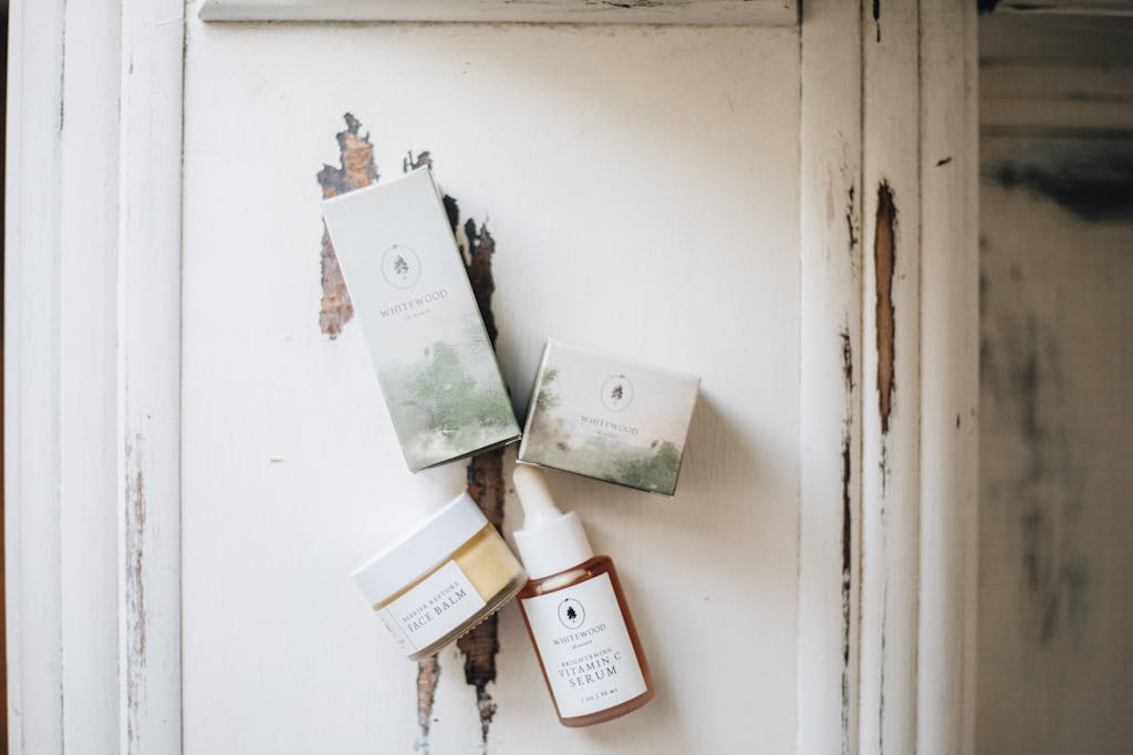 Luxury skincare set with face serum and balm in minimalist style, photographed on a rustic surface.