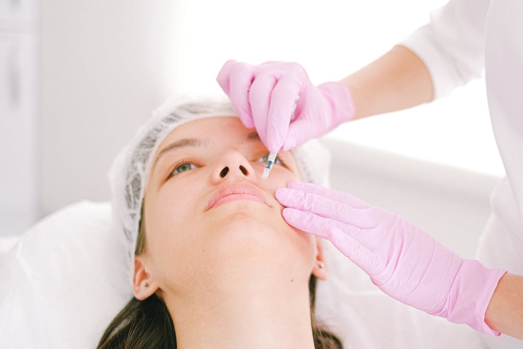 Woman receiving a facial cosmetic injection in a professional clinic setting.
