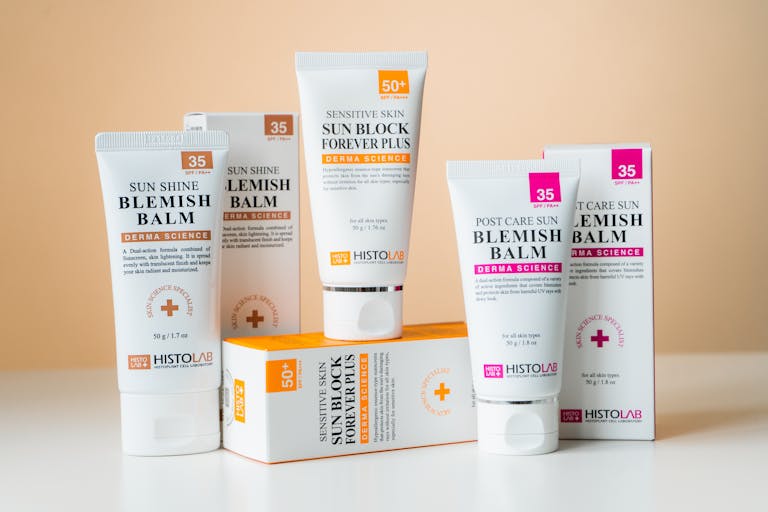 A collection of skincare products including blemish balms and sunblock for sensitive skin with SPF protection.