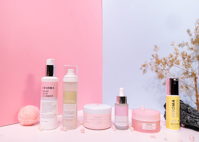 Aesthetic product photography of skincare items on a pink and blue background.