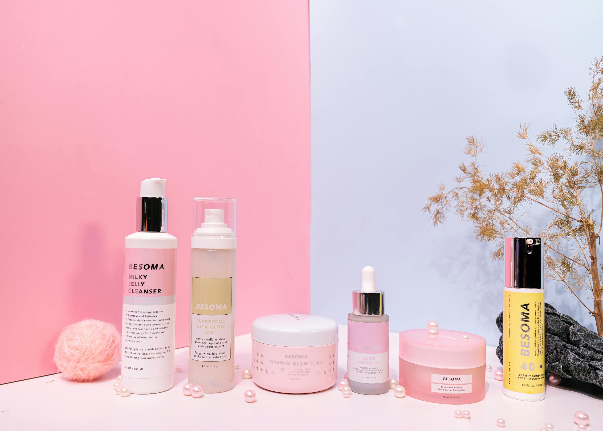 Aesthetic product photography of skincare items on a pink and blue background.