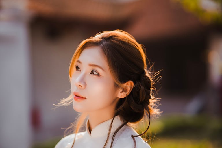 Beautiful portrait of a woman in traditional attire during golden hour.